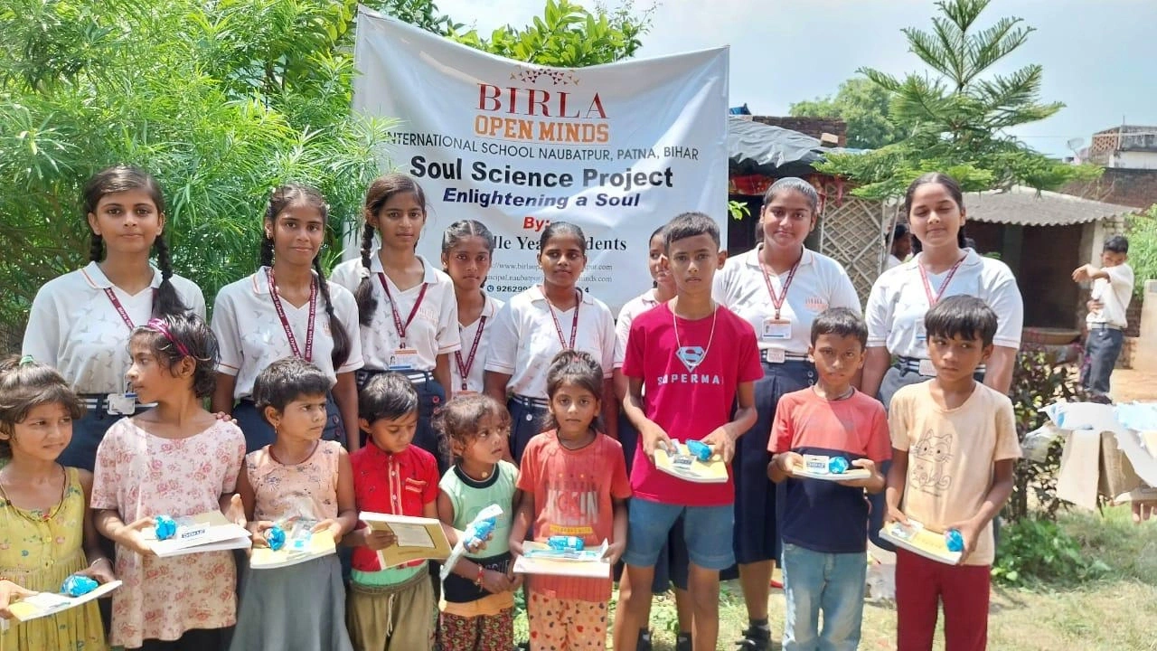 Students sharing Soul Science learning materials with children in the local community