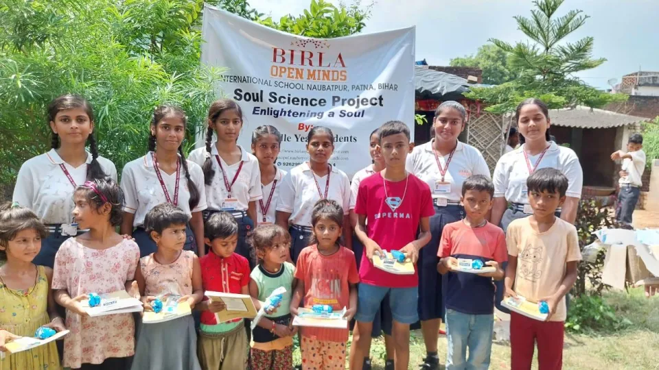 Students sharing Soul Science learning materials with children in the local community